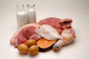 Different kinds of meat, eggs and two bottles of milk